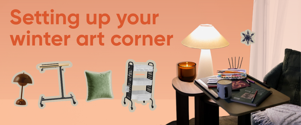 A cosy winter art corner set up with a lamp, blanket and art supplies on a mobile craft cart