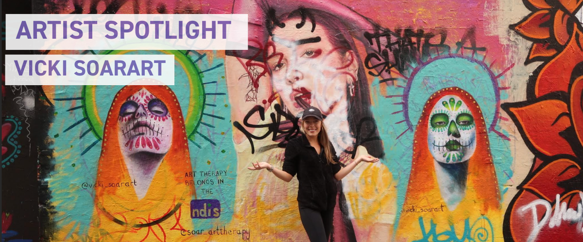 Art therapist Vicki painting a colourful Melbourne street mural promoting healing through creative expression