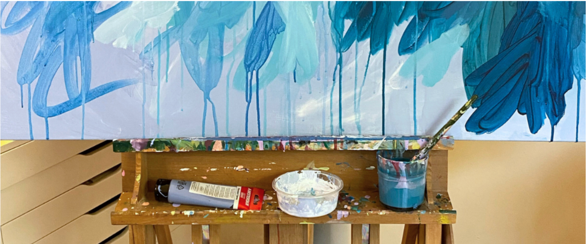 Hands squeezing paint from various acrylic brands onto palettes with a cheeky Art Shed CTA encouraging artists to try new paints.