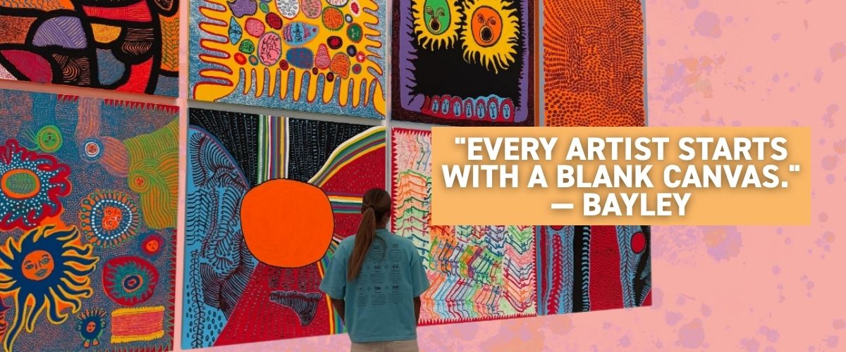 Bayley Mifsud standing in front of her completed Aboriginal-inspired mural artwork