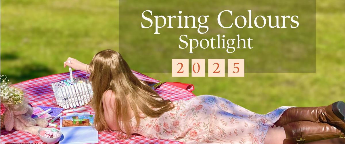 Artist painting outdoors on a picnic blanket with spring pastels, surrounded by sketchbooks, paints, and natural light — en plein air inspiration in action