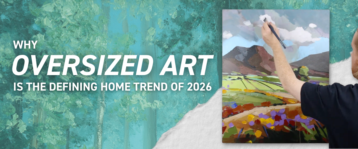 Banner reading Why Oversized Art is the Defining Home Trend of 2026, showing an artist's hand painting a large mountain landscape